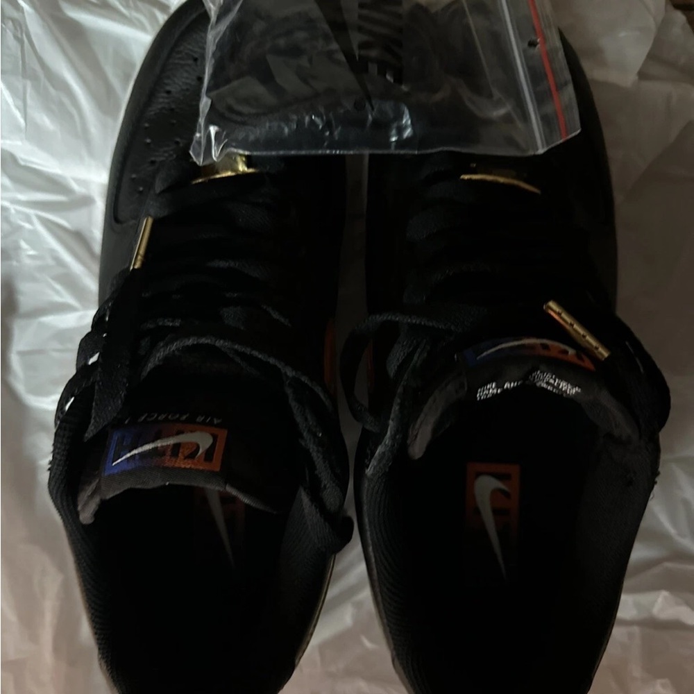 Nike Black Low-Top Sneakers with Orange Logo and Gold Accents